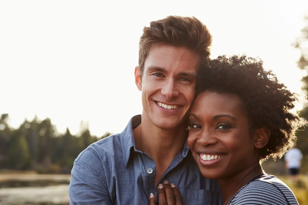 Happy couple | ames center for counseling | ames center for counseling A man and woman smile as they cuddle together